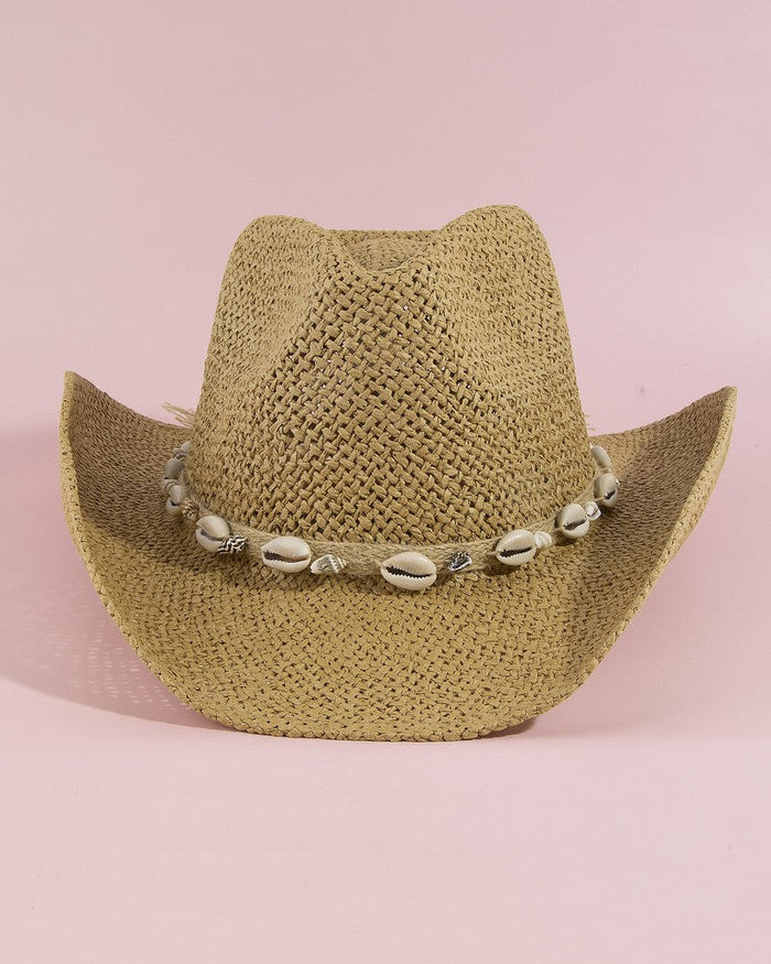 Beige cowboy hat with a shell band on a pink background